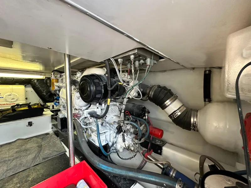 Slide: The Image of Engine room of 2002 Custom Carolina 40 Express Sportfisherman, showcasing mechanical components and wiring. - 41