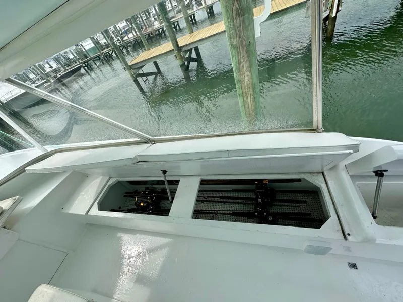 Slide: The Image of 2002 Custom Carolina 40 Express Sportfisherman with open storage compartment at dock. - 45