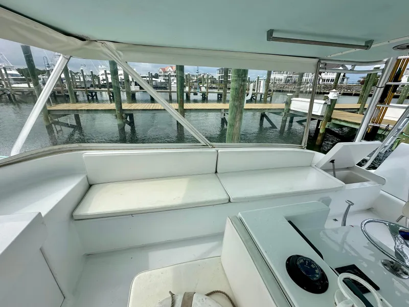 Slide: The Image of 2002 Custom Carolina 40 Express Sportfisherman interior with seating and marina view. - 46