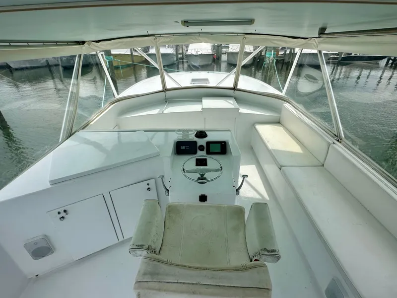 Slide: The Image of Helm of 2002 Custom Carolina 40 Express Sportfisherman with seating and steering wheel. - 47