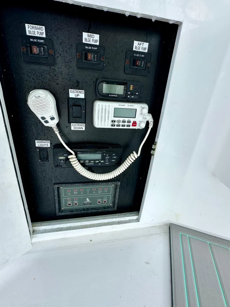 Slide: The Image of Control panel of 2002 Custom Carolina 40 Express Sportfisherman with bilge pump switches and radio. - 48