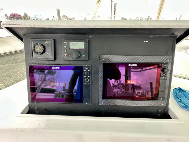 Slide: The Image of Control panel of 2002 Custom Carolina 40 Express Sportfisherman with Simrad displays. - 49