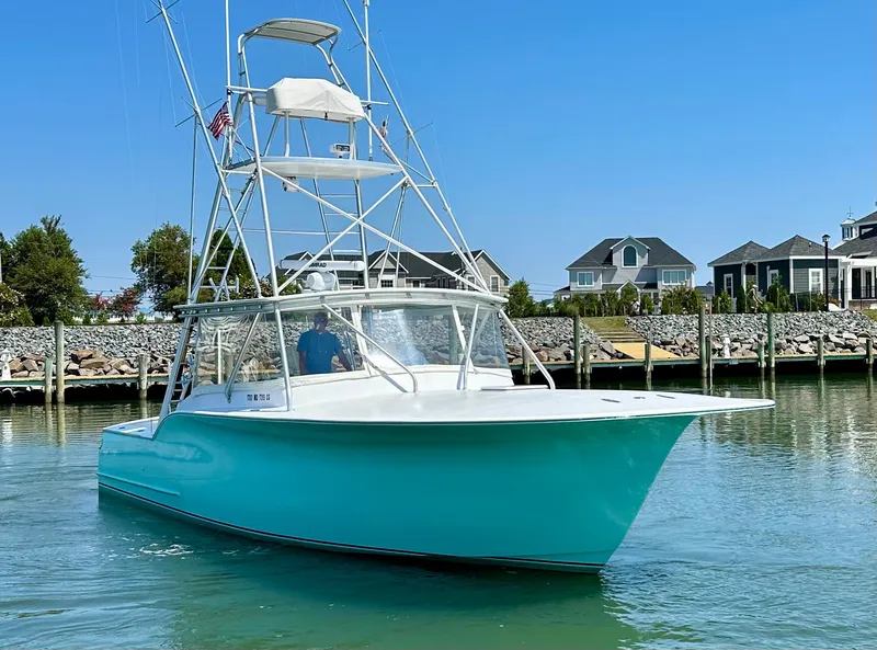 Slide: The Image of 2002 Custom Carolina 40 Express Sportfisherman in marina, clear sky, waterfront homes. - 5