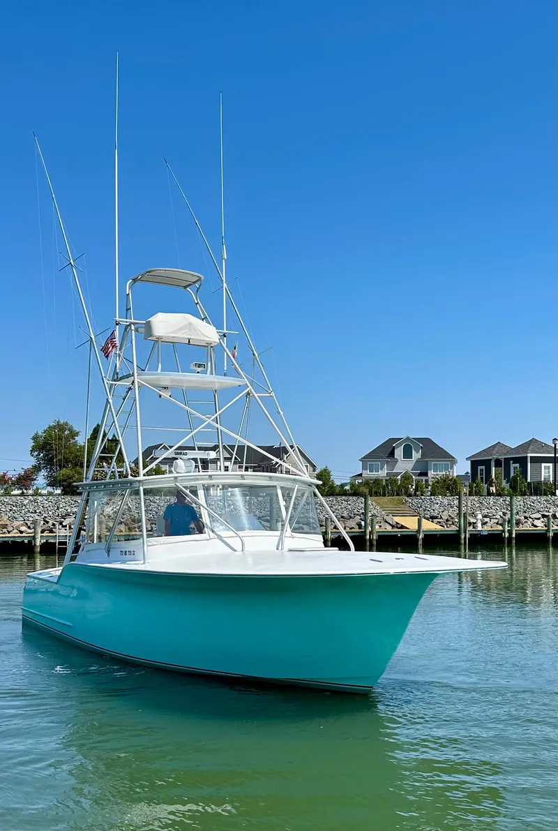 Slide: The Image of 2002 Custom Carolina 40 Express Sportfisherman in calm waters, clear sky background. - 6