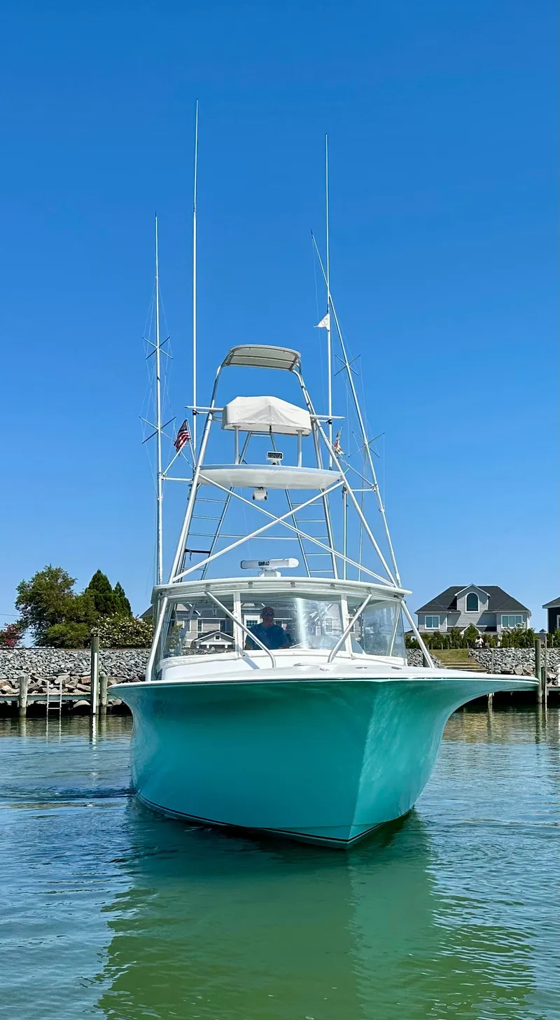 Slide: The Image of Custom Carolina 40 Express Sportfisherman, 2002 model, docked in a serene marina setting. - 7