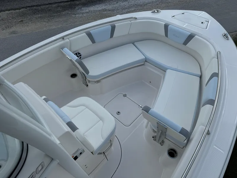 Slide: The Image of 2025 Robalo R230 Center Console boat interior with cushioned seating and storage compartments. - 12