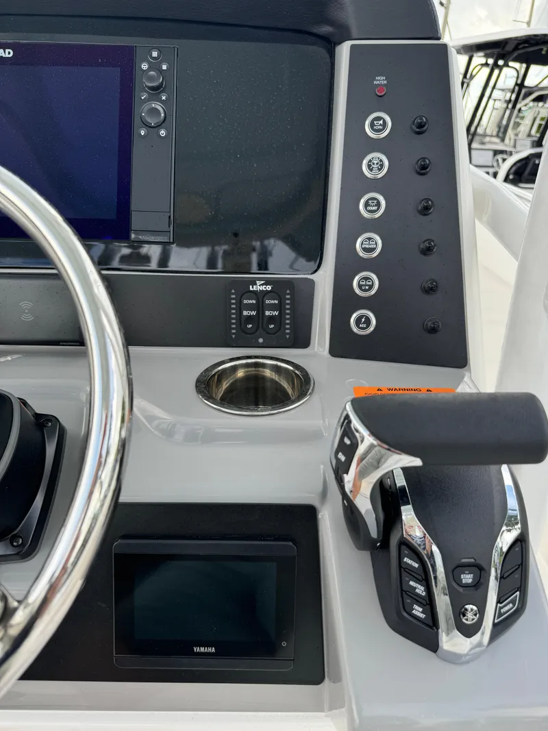 Slide: The Image of 2025 Robalo R230 Center Console dashboard with steering wheel, controls, and display screens. - 20