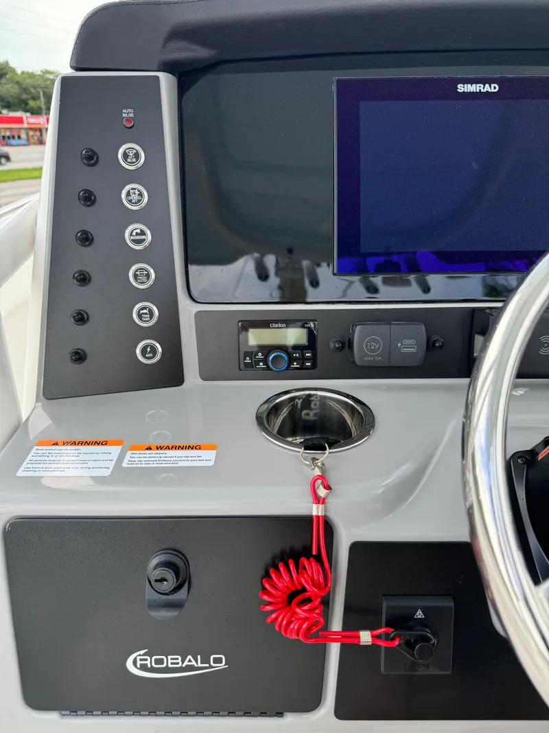 Slide: The Image of 2025 Robalo R230 Center Console dashboard with Simrad display and control panel. - 21