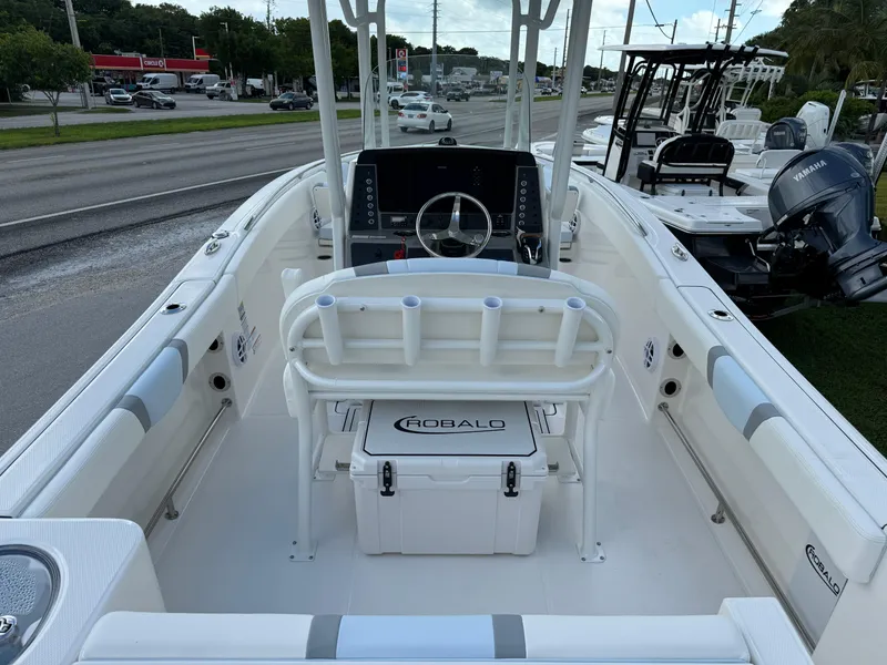 Slide: The Image of 2025 Robalo R230 Center Console boat interior with steering wheel and seating. - 6
