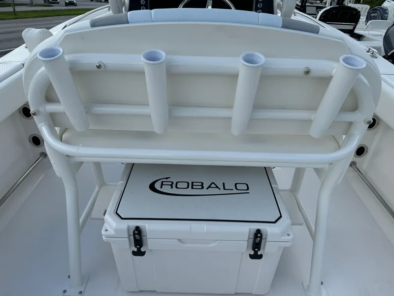 Slide: The Image of 2025 Robalo R230 Center Console boat with rod holders and branded cooler. - 7