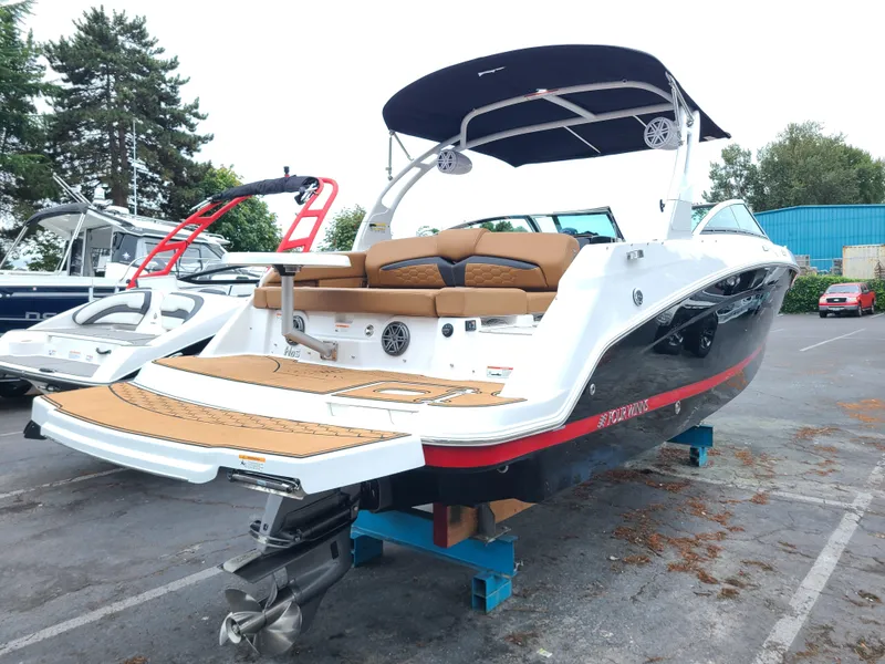 Slide: The Image of 2023 Four Winns HD5 boat with sleek design, parked outdoors. - 3