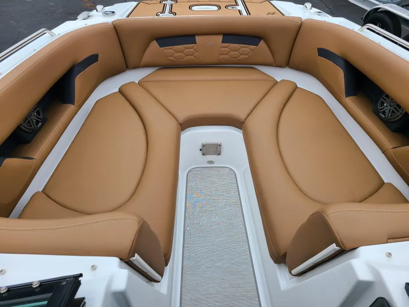 Slide: The Image of 2023 Four Winns HD5 boat interior with tan leather seating and modern design. - 4