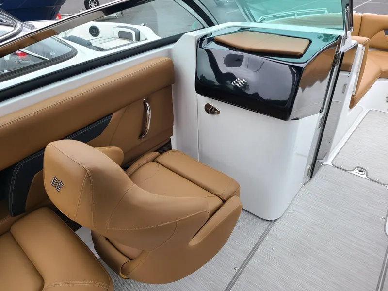 Slide: The Image of 2023 Four Winns HD5 boat interior with tan leather seating and sleek design. - 8