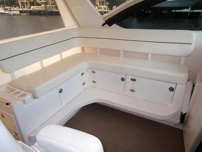 Slide: The Image of Curved Settee to Port with Storage Lockers Below - 14