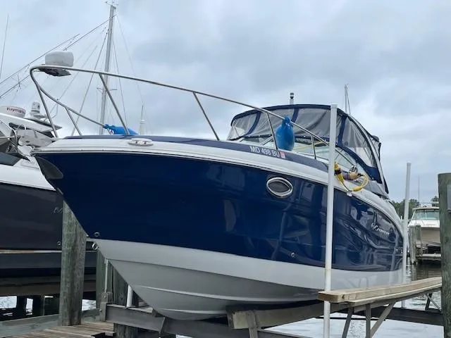 The Image of 2023 Crownline 270 CR boat docked at marina, blue and white exterior. - 0