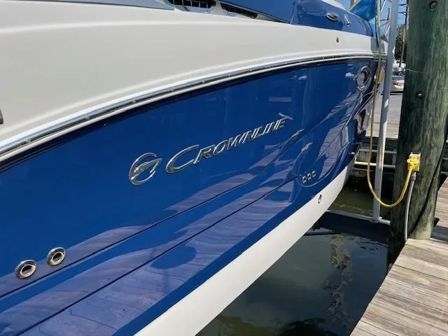 Slide: The Image of 2023 Crownline 270 CR boat docked, blue and white exterior. - 3