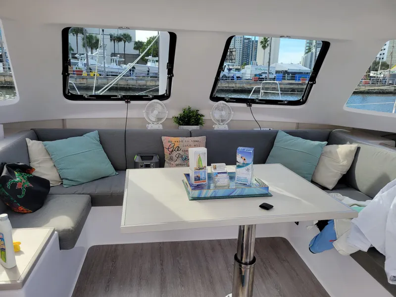 Slide: The Image of Interior of 2019 Seawind 1160 Lite catamaran with cozy seating and table setup. - 11