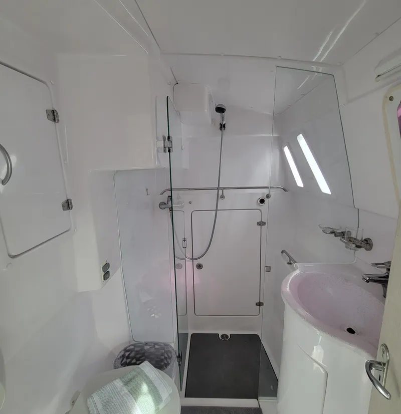 Slide: The Image of 2019 Seawind 1160 Lite yacht bathroom with shower, sink, and modern fixtures. - 13