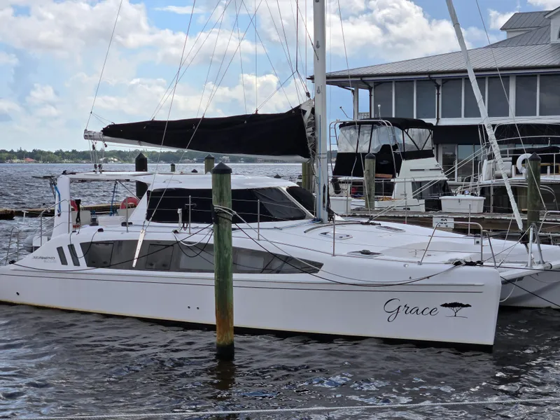 Slide: The Image of 2019 Seawind 1160 Lite catamaran docked at marina, named "Grace." - 4