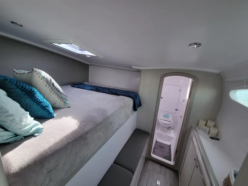 Slide: The Image of Interior of 2019 Seawind 1160 Lite catamaran cabin with bed and ensuite bathroom. - 6