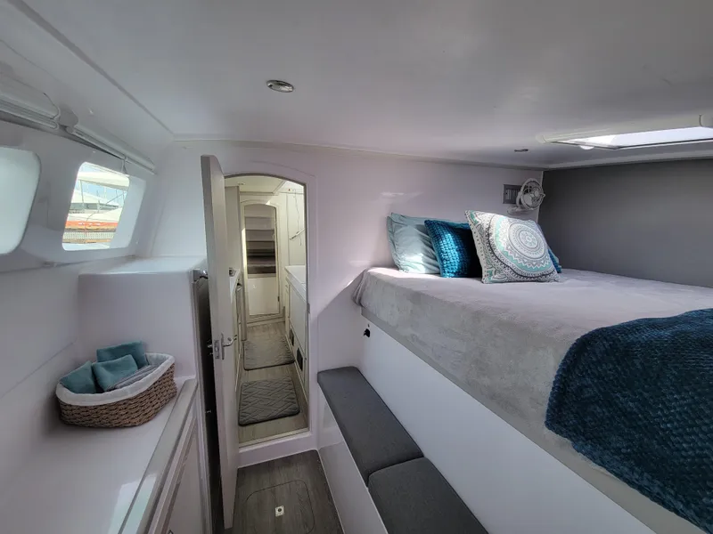 Slide: The Image of Interior of 2019 Seawind 1160 Lite catamaran, featuring cozy bedroom with modern decor. - 7