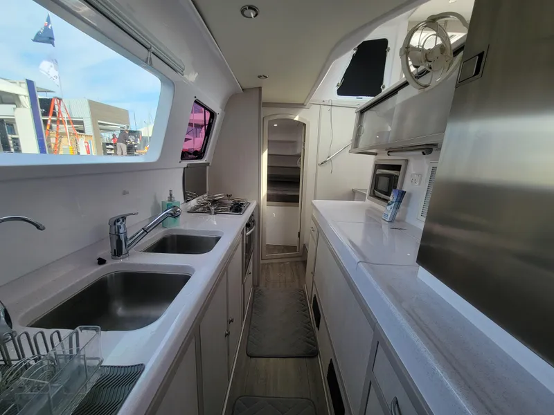 Slide: The Image of Modern kitchen interior of 2019 Seawind 1160 Lite catamaran with dual sinks and appliances. - 8