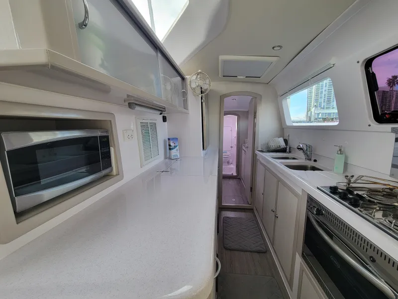 Slide: The Image of Interior of 2019 Seawind 1160 Lite catamaran kitchen with modern appliances. - 9