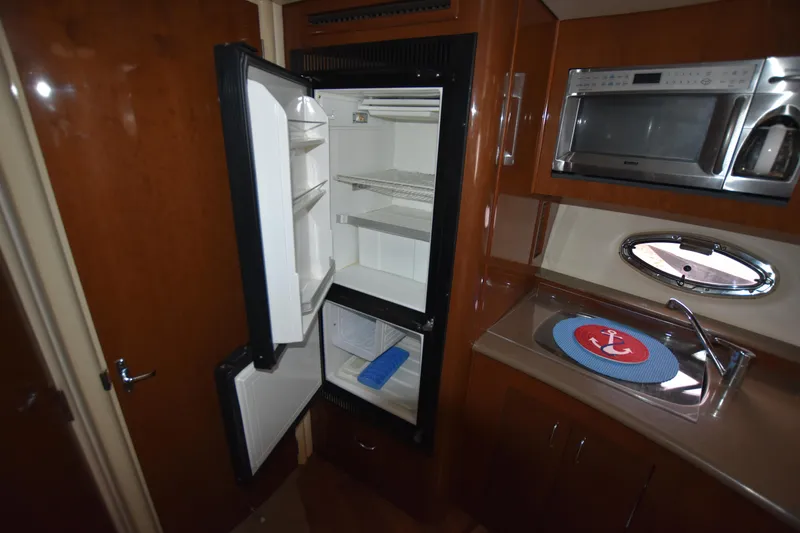 Slide: The Image of 2007 Carver 36 Mariner kitchen with open fridge, microwave, and sink. - 13