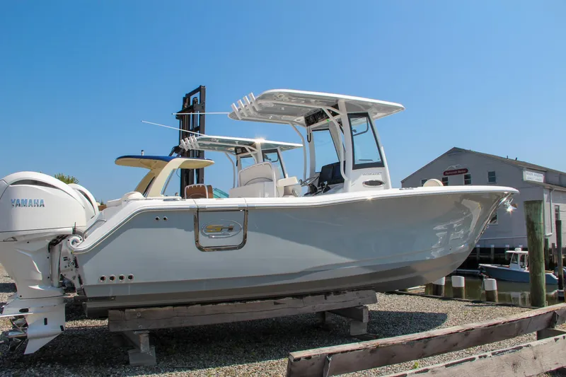 Slide: The Image of 2025 Sea Hunt Ultra 275 SE boat on display at a marina. - 11