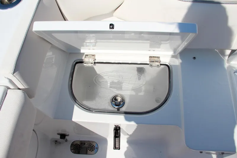 Slide: The Image of 2025 Sea Hunt Ultra 275 SE boat storage compartment with open lid. - 17