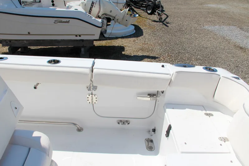 Slide: The Image of 2025 Sea Hunt Ultra 275 SE boat interior with white seating and storage compartments. - 19