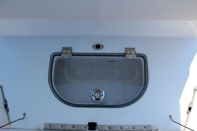 Slide: The Image of 2025 Sea Hunt Ultra 275 SE boat hatch detail with secure latch. - 25
