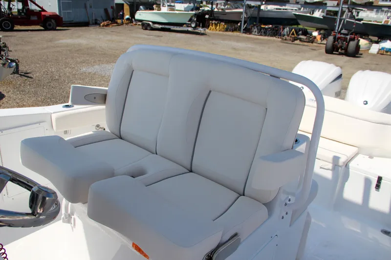 Slide: The Image of 2025 Sea Hunt Ultra 275 SE boat seating in a marina setting. - 31