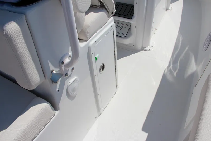 Slide: The Image of Interior view of 2025 Sea Hunt Ultra 275 SE boat, featuring white seating and storage compartment. - 32