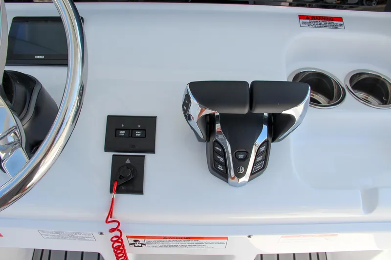 Slide: The Image of 2025 Sea Hunt Ultra 275 SE boat controls and dashboard with steering wheel. - 35