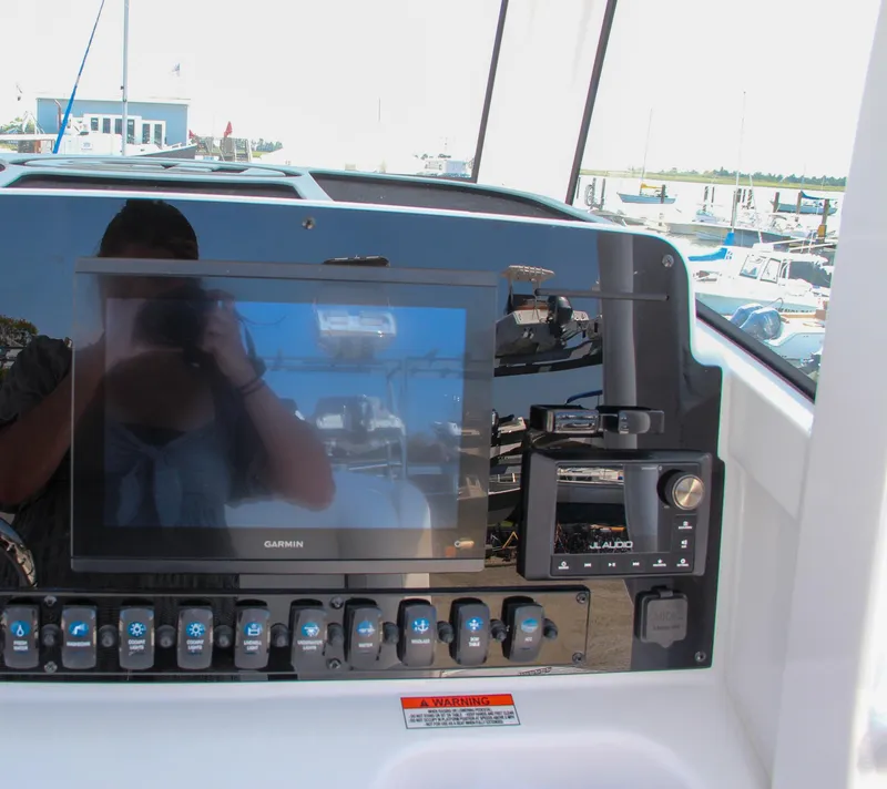 Slide: The Image of Sea Hunt Ultra 275 SE 2025 dashboard with Garmin display and controls. - 36