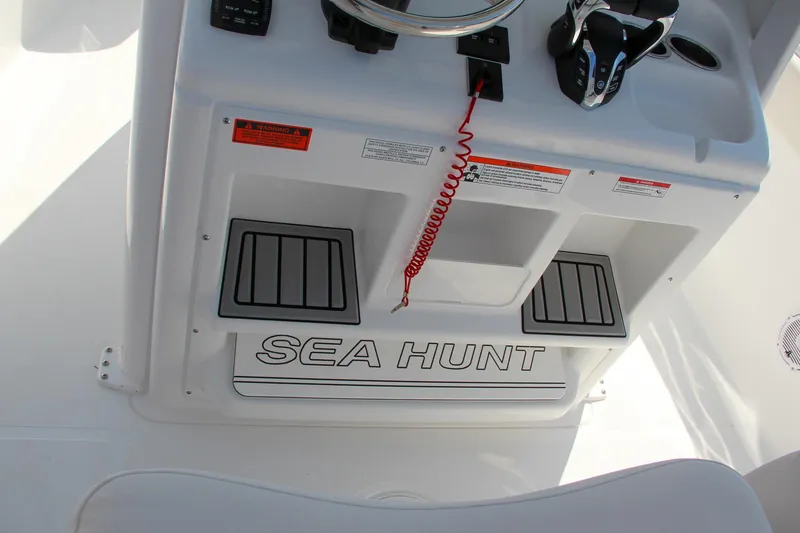 Slide: The Image of 2025 Sea Hunt Ultra 275 SE boat console with branding and controls. - 37