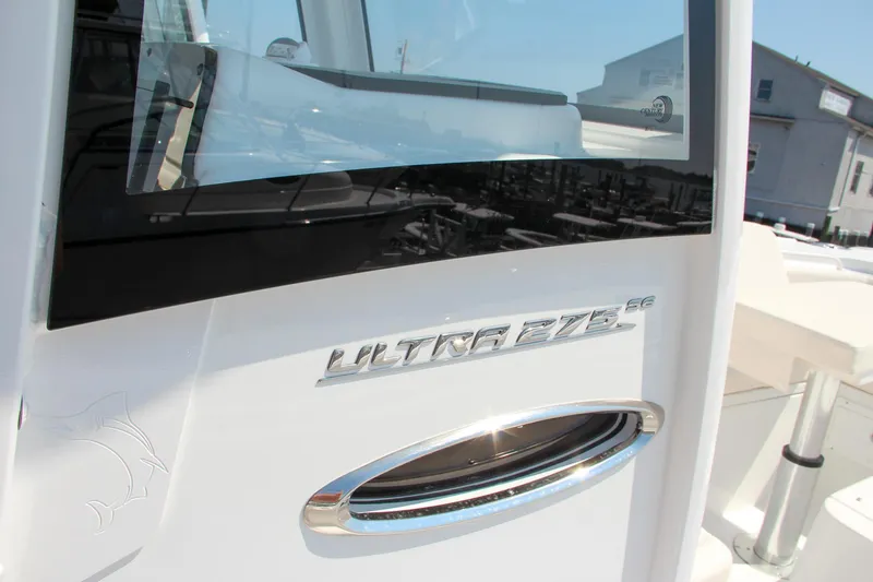 Slide: The Image of Close-up of 2025 Sea Hunt Ultra 275 SE boat exterior with logo and window. - 39