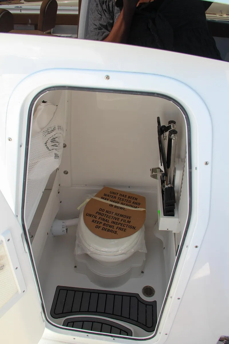 Slide: The Image of 2025 Sea Hunt Ultra 275 SE boat interior with compact marine toilet. - 41