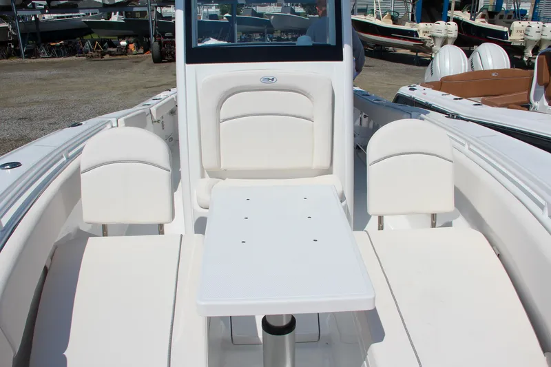 Slide: The Image of 2025 Sea Hunt Ultra 275 SE boat interior with seating and table. - 43