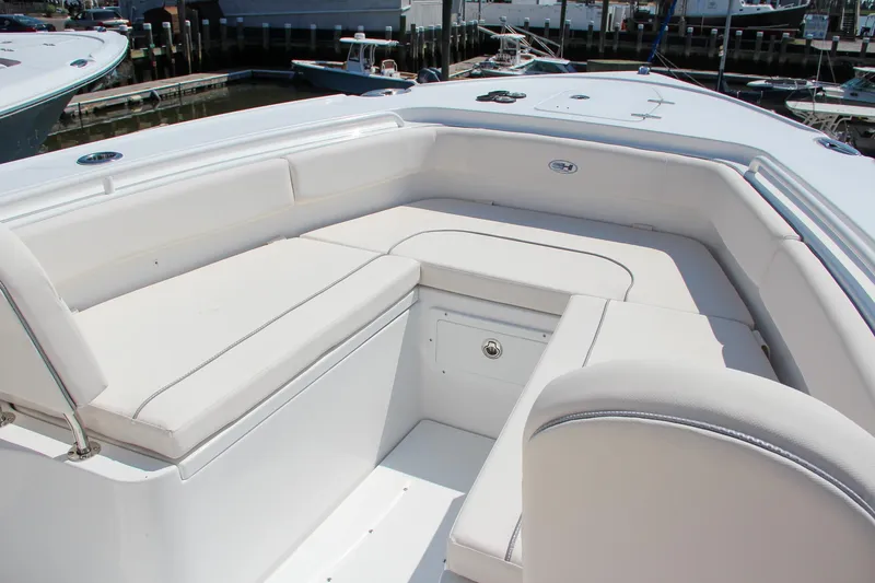Slide: The Image of 2025 Sea Hunt Ultra 275 SE boat with spacious white seating area. - 48