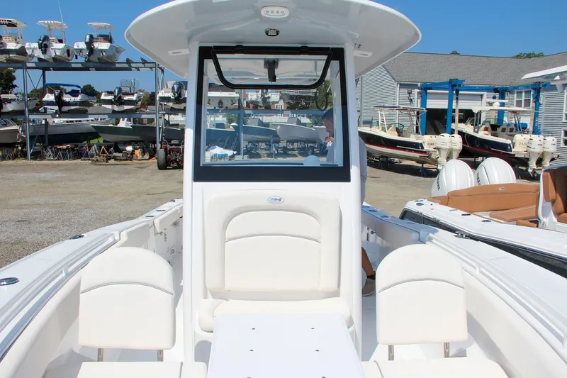 Slide: The Image of 2025 Sea Hunt Ultra 275 SE boat interior at a marina with other boats. - 7