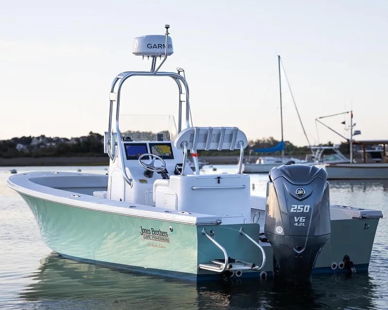 Slide: The Image of 2024 Jones Brothers 23 Cape Fisherman boat with Yamaha 250 V6 engine in calm waters. - 1