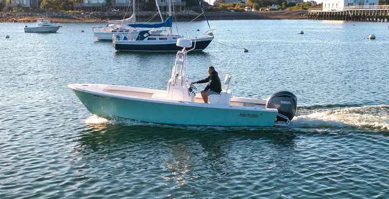 Slide: The Image of 2024 Jones Brothers 23 Cape Fisherman boat cruising on a calm sea. - 10