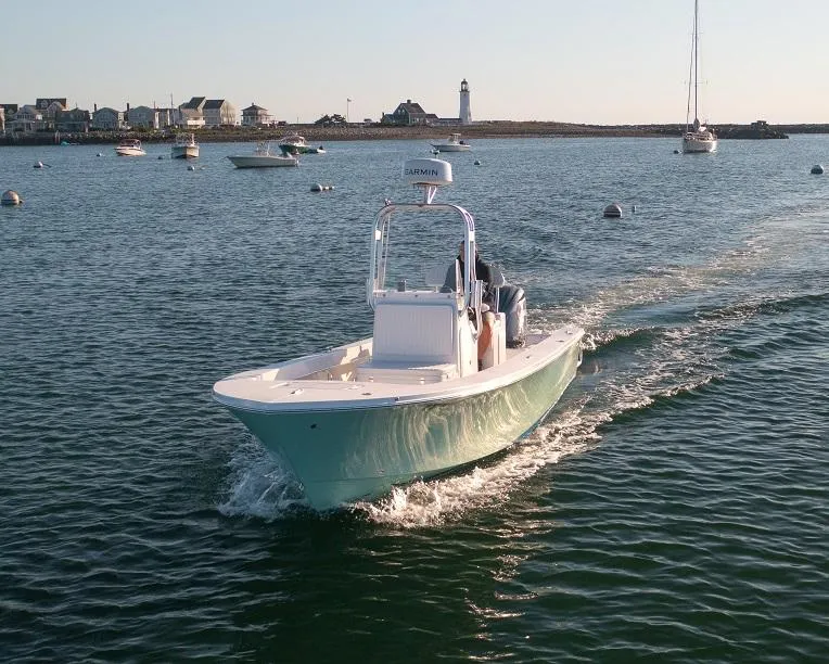 Slide: The Image of 2024 Jones Brothers 23 Cape Fisherman boat cruising in a scenic harbor. - 11