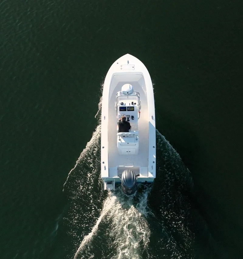 Slide: The Image of Aerial view of 2024 Jones Brothers 23 Cape Fisherman boat cruising on water. - 12
