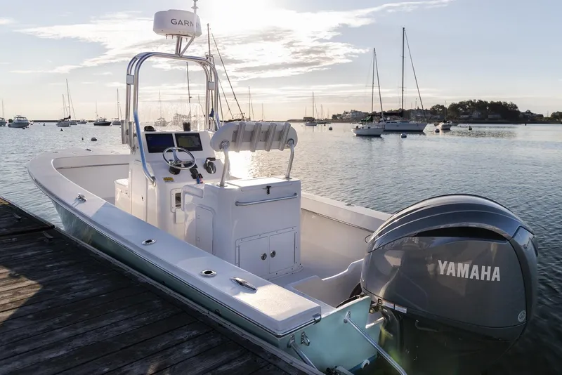 Slide: The Image of 2024 Jones Brothers 23 Cape Fisherman boat docked with Yamaha engine. - 2
