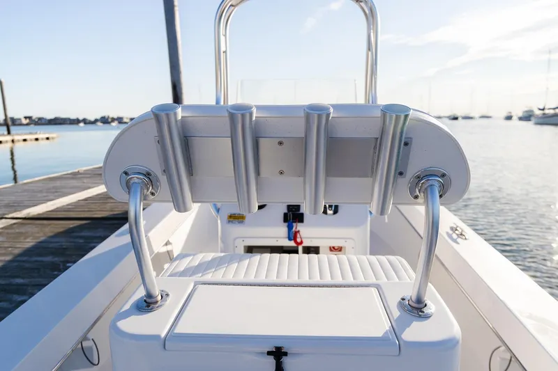 Slide: The Image of 2024 Jones Brothers 23 Cape Fisherman boat interior with rod holders at dock. - 4