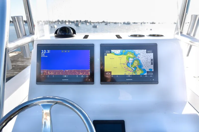 Slide: The Image of 2024 Jones Brothers 23 Cape Fisherman boat dashboard with dual Garmin displays. - 7