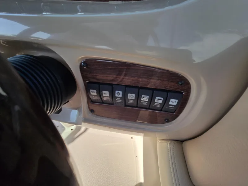 Slide: The Image of Control panel of a 2005 Chaparral 236 Sunesta boat with labeled switches. - 16